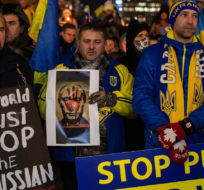 People take part in a rally in support of Ukraine after Russia invaded Ukraine, in Edmonton on Thursday February 24, 2022. Jason Franson/The Canadian Press.