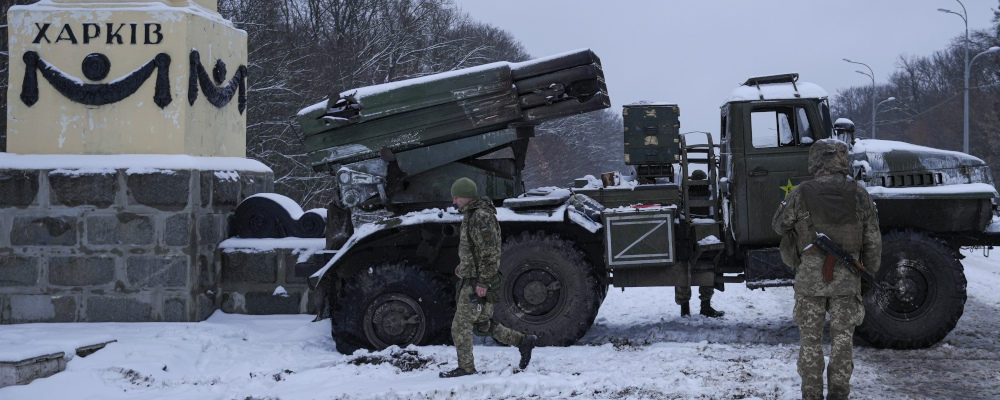 Ukrainian servicemen walk by a deactivated Russian military multiple rocket launcher on the outskirts of Kharkiv, Ukraine on Feb. 25, 2022. Vadim Ghirda/AP Photo.