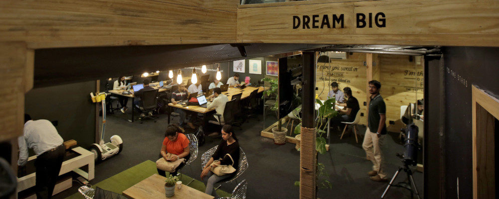 Young Indian entrepreneurs and freelancers work inside Innov8, a lax co-working space in New Delhi, India. Altaf Qadri/AP Photo.