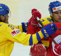 Artyom Shvets-Rogovoi of Russia, right, scuffle with Magnus Nygren of Sweden during the Ice Hockey World Championship group A match between the Russia and Sweden at the Olympic Sports Center in Riga, Latvia, Monday, May 31, 2021. Roman Koksarov/AP Photo.