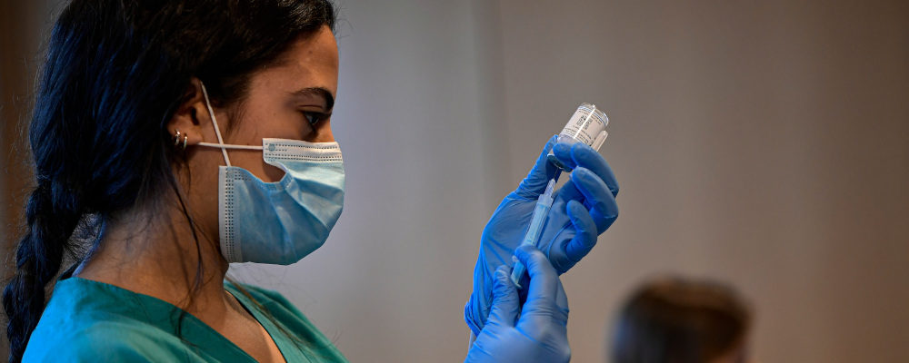 A medical staff member prepares a dose of the  Moderna COVID-19 vaccine, at San Pedro Hospital in Logrono, northern Spain, Tuesday, Jan. 18. 2022. Alvaro Barrientos/AP Photo.