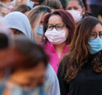 Black Friday shoppers wearing face masks wait in line to enter a store at the Citadel Outlets in Commerce, Calif., Friday, Nov. 26, 2021. Ringo H.W. Chiu, File/AP Photo.