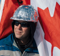 James, no last name given, prepares to protest COVID-19 mandates in Edmonton, Tuesday, Feb. 22 2022. His tinfoil hard hat is meant to claim and disarm accusations of conspiracy theorists. Amber Bracken/The Canadian Press.