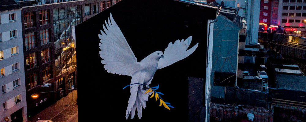 A peace mural showing a dove with a branch in Ukrainian colors by artist Justus Becker is painted on the wall of a house in Frankfurt, Germany, Monday, Feb. 28, 2022. Michael Probst/AP Photo.