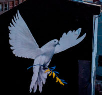 A peace mural showing a dove with a branch in Ukrainian colors by artist Justus Becker is painted on the wall of a house in Frankfurt, Germany, Monday, Feb. 28, 2022. Michael Probst/AP Photo.