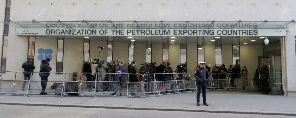 People stand in front of the headquarters of the Organization of the Petroleum Exporting Countries, OPEC, in Vienna, Austria, Thursday, March 5, 2020. Ronald Zak/AP Photo.