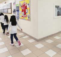 Children walk back to their classroom while physical distancing after picture day at St. Barnabas Catholic School in Scarborough on October 27, 2020. Nathan Denette/The Canadian Press.