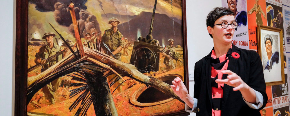 Curator Lindsey Sharman speaks about Second World War silkscreens, that brightened the living quarters of Canadian soldiers, on display at the Founders’ Gallery at The Military Museums in Calgary, Alta., Thursday, Nov. 5, 2015. Jeff McIntosh/The Canadian Press.