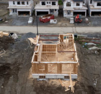 In this photo taken using a drone, homes under construction are seen in a new suburb, Friday, Oct. 15, 2021 in Ottawa.  Adrian Wyld/The Canadian Press.
