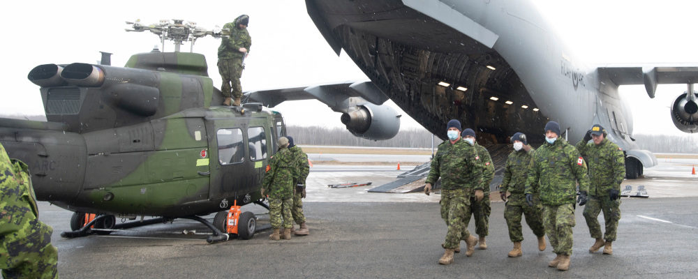 A CH-146 Griffon helicopter is loaded on board a C-177 Globemaster III as the Canadian Armed Forces send relief to the flooded areas in British Columbia, Friday, November 19, 2021 in Quebec City. Jacques Boissinot/The Canadian Press.