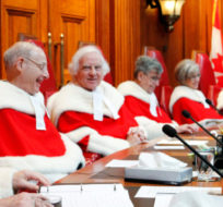 Justice Michael Moldaver (left) shares a laugh with his Supreme Court colleagues during a welcoming ceremony in the Supreme Court of Canada, Monday November 14, 2011. Fred Chartrand/The Canadian Press.