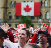 People take in the Canada 150 celebrations on Parliament Hill in Ottawa on Saturday, July 1, 2017. Sean Kilpatrick/The Canadian Press.