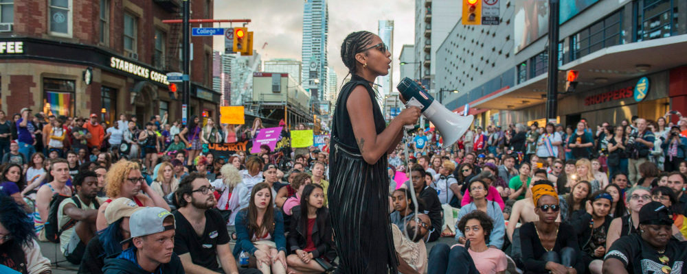 Black Lives Matter activist Janaya Khan organizes a sit-in at Yonge st. and College st. during the Trans Pride March, in Toronto on Friday July 1 , 2016. Eduardo Lima/The Canadian Press.