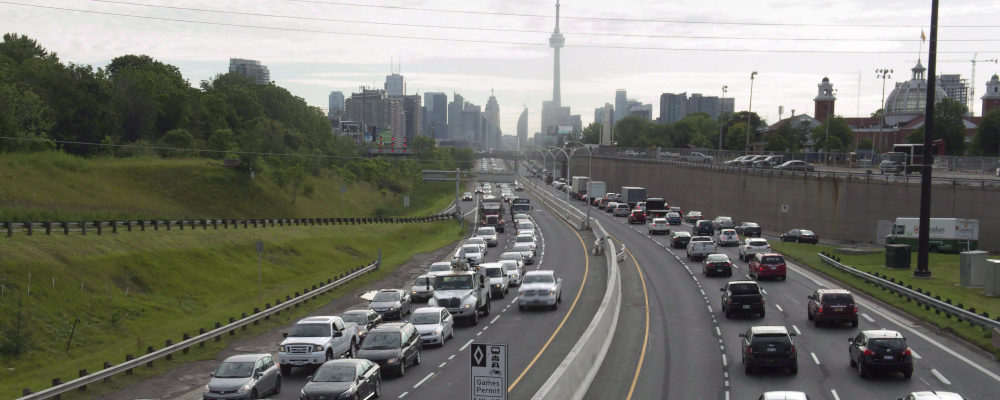 Vehicles travel along the nearly-empty Pan Am high-occupancy vehicle lanes as morning rush hour traffic crawls in Toronto on Monday, June 29, 2015. Frank Gunn/The Canadian Press.