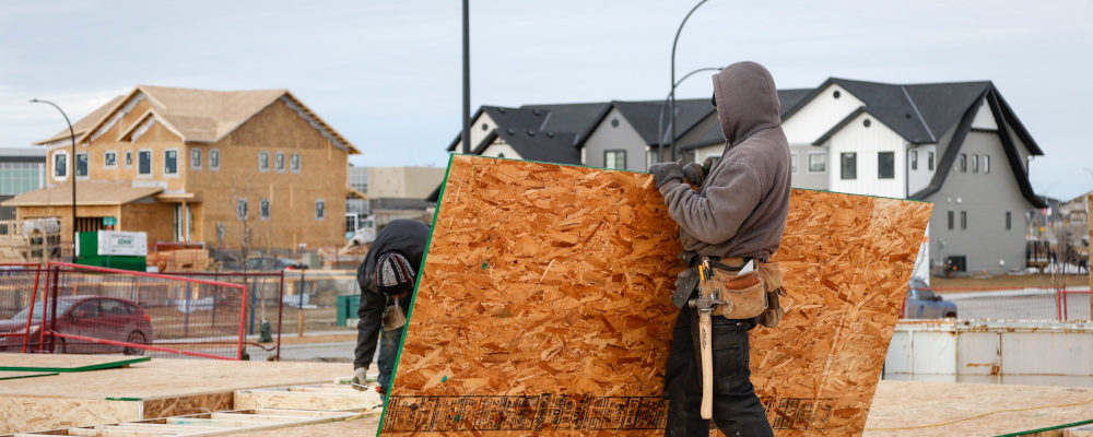 Framers work on a new house under construction in Airdrie, Alta., Friday, Jan. 28, 2022. Jeff McIntosh/The Canadian Press.