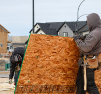 Framers work on a new house under construction in Airdrie, Alta., Friday, Jan. 28, 2022. Jeff McIntosh/The Canadian Press.