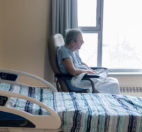 A resident sits in his room at Idola Saint-Jean long-term care home in Laval, Que., Friday, February 25, 2022. Graham Hughes/The Canadian Press.