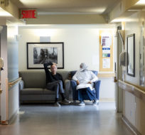A resident talks with a health-care worker in a COVID-19 infected ward at Idola Saint-Jean long-term care home in Laval, Que., Friday, February 25, 2022. Graham Hughes/The Canadian Press.