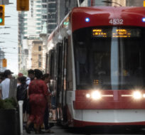 Transit riders board a streetcar in downtown Toronto on Wednesday, July 10, 2019. Graeme Roy/The Canadian Press.