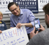Four-year-old Graeme Ballingall has a photo taken with federal Conservative leadership candidate Pierre Poilievre after a campaign rally in Toronto, Saturday, April 30, 2022. Chris Young/The Canadian Press.