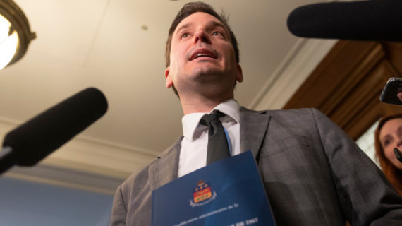 Quebec Justice Minister and French Language Minister Simon Jolin-Barrette holds a book containing the 1867 Canadian constitution and the Canadian Act during a news conference, Wednesday, June 8, 2022 at the legislature in Quebec City. Jacques Boissinot/The Canadian Press.