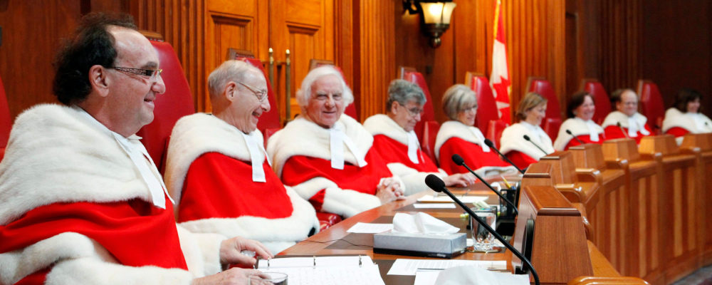 Justice Michael Moldaver (left) shares a laugh with his Supreme Court colleagues during a welcoming ceremony in the Supreme Court of Canada, Monday November 14, 2011. Fred Chartrand/The Canadian Press.