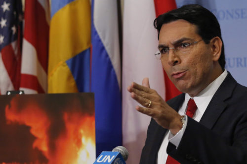 Israel United Nations Ambassador Danny Danon points to an image showing a fiery scene while discussing violence along the border  between Israel and the Gaza Strip on May 15, 2018 at U.N. headquarters. Bebeto Matthews/AP Photo.