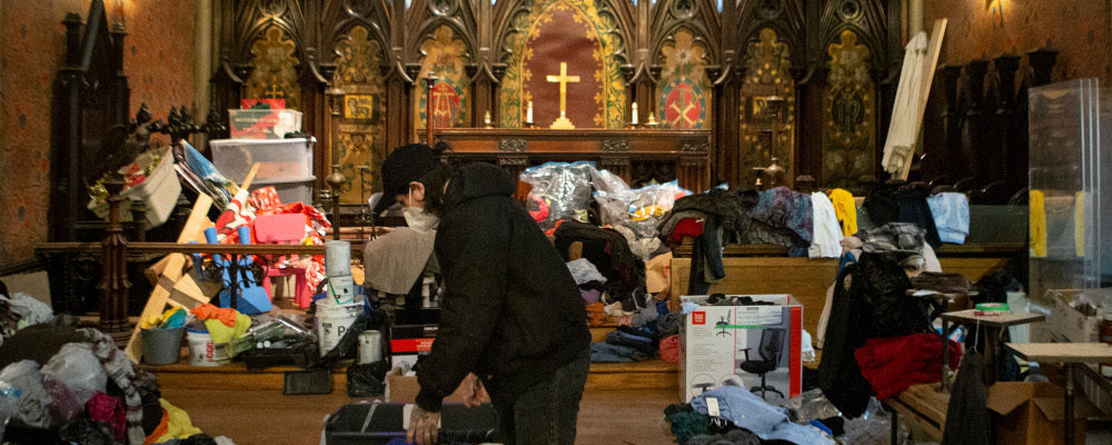 Zack Grant from Toronto's Holy Trinity Church sifts through donations for those in need, on Tuesday, January 11, 2022. Chris Young/The Canadian Press.