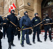 Police move in to clear downtown Ottawa near Parliament hill of protesters after weeks of demonstrations on Saturday, Feb. 19, 2022. Cole Burston/The Canadian Press.