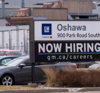A sign announcing hiring sits at the General Motors facility in Oshawa, Ontario on Monday April 4, 2022. Frank Gunn/The Canadian Press.