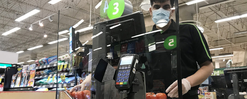 A plexiglass barrier is pictured creating a barrier to protect a cashier at a grocery store in North Vancouver, B.C. Sunday, March 22, 2020. Jonathan Hayward/The Canadian Press.