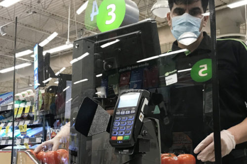 A plexiglass barrier is pictured creating a barrier to protect a cashier at a grocery store in North Vancouver, B.C. Sunday, March 22, 2020. Jonathan Hayward/The Canadian Press.