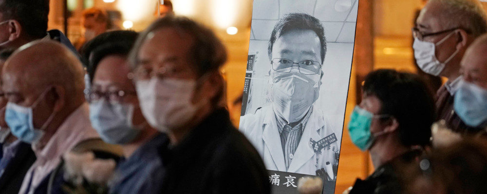 In this Feb. 7, 2020 file photo, people wearing masks attend a vigil for Chinese doctor Li Wenliang, in Hong Kong. The outpouring of grief and rage sparked by Li's death was an unusual - and for the Chinese Communist Party, unsettling - display in China's tightly monitored civic space. Kin Cheung/AP Photo.