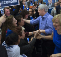 Conservative leader Stephen Harper and his wife Laureen greet supporters as he attends a rally in Laval, Que., during a campaign event on Oct. 17, 2015.  Canadians will go to the polls in the federal election Oct. 19. Jonathan Hayward/The Canadian Press.