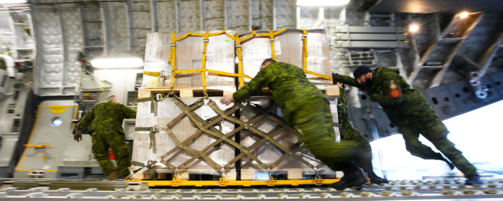 Royal Canadian Air Force personnel load non-lethal and lethal aid at CFB Trenton, Ontario on Monday, March 7, 2022. The cargo is bound for the Ukrainian via Poland.  Sean Kilpatrick/The Canadian Press.