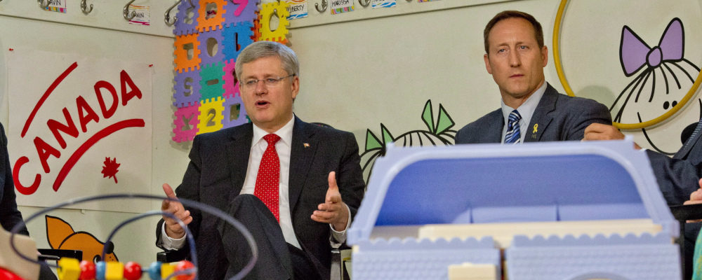 Peter MacKay looks on as Prime Minister Stephen Harper speaks in Toronto on August 29, 2013. Frank Gunn/The Canadian Press.