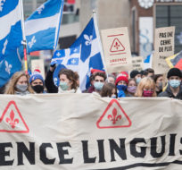 People take part in a demonstration in Montreal, Saturday, November 28, 2020, where they protested against government funding for infrastructure projects at two English-language educational institutions and also calling on the city of Montreal to set up a body to protect the French language. Graham Hughes/The Canadian Press. 