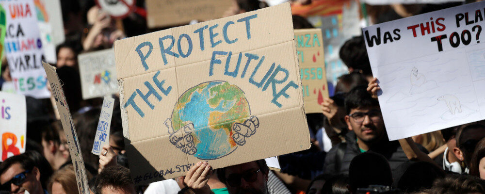 Demonstrators hold up signs during a Fridays for Future rally demanding more action be taken to save the environment, in Rome, Friday, April 19, 2019. Alessandra Tarantino/AP Photo.