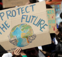 Demonstrators hold up signs during a Fridays for Future rally demanding more action be taken to save the environment, in Rome, Friday, April 19, 2019. Alessandra Tarantino/AP Photo.