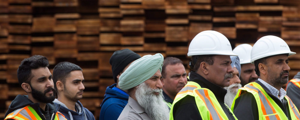 Mill workers listen as British Columbia Premier Christy Clark speaks about U.S. import duties on Canadian softwood lumber, at Partap Forest Products in Maple Ridge, B.C., on Tuesday April 25, 2017. Darryl Dyck/The Canadian Press. 