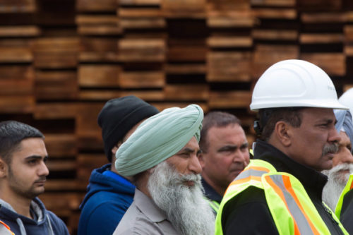 Mill workers listen as British Columbia Premier Christy Clark speaks about U.S. import duties on Canadian softwood lumber, at Partap Forest Products in Maple Ridge, B.C., on Tuesday April 25, 2017. Darryl Dyck/The Canadian Press. 
