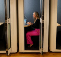 Kelly Soderlund works in a quiet booth at the TripActions office in San Francisco, Friday, Aug. 27, 2021. Switching to a hybrid work model is ideal for people like Soderlund, a mother of two young children who works in offices in San Francisco and Palo Alto, California. Eric Risberg/AP Photo.