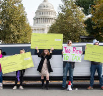 Satirical "corporations and the wealthy" protest outside the U.S. Capitol in support of tax increases in the Build Back Better plan on Thursday, Nov. 4, 2021, in Washington. Joy Asico/AP Images.