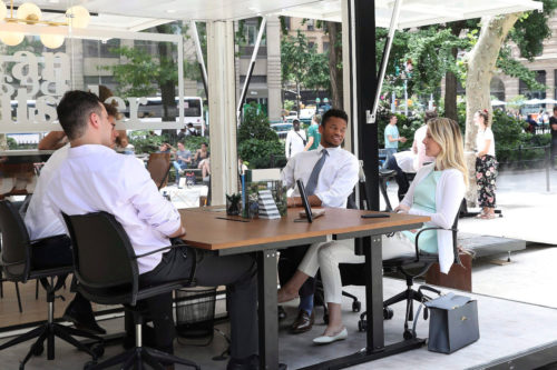 A team takes their meeting outdoors to enjoy the benefits of working outside ‚Äì increased productivity, creativity and happiness at the debut of the first-ever outdoor coworking space by L.L.Bean and Industrious in New York, Wednesday, June 20, 2018. Amy Sussman/AP Images for L.L.Bean.