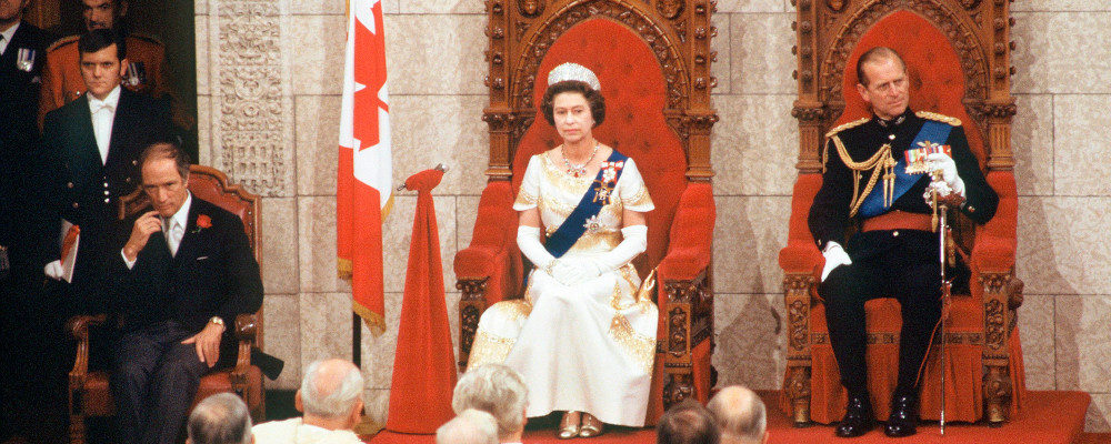 Prime Minister Trudeau, Queen Elizabeth II and Prince Philip sit in the Senate Chambers to officially open the session of Parliament, in Ottawa, Oct. 18, 1977. Staff/The Canadian Press.