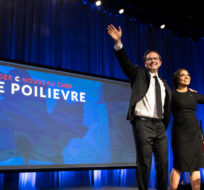 Conservative Party of Canada Leader Pierre Poilievre and his wife Anaida wave on stage after he was announced as the winner at the Conservative Party of Canada leadership vote, in Ottawa, on Saturday, Sept. 10, 2022. Justin Tang/The Canadian Press. 