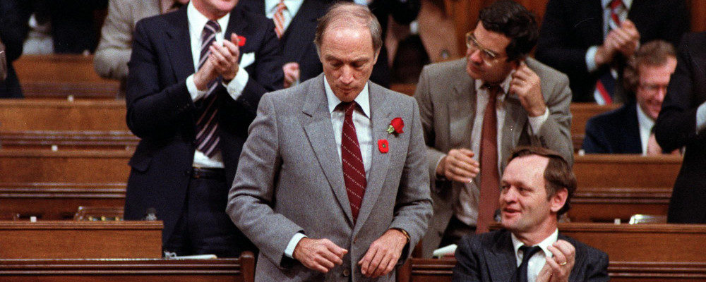 Prime Minister Pierre Trudeau gets a round of applause from Liberal members in the House of Commons after signing an accord with the provinicial premiers on the constitutional talks in Ottawa, Thursday, Nov. 5, 1981. Fred Chartrand/CP Photo.