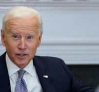President Joe Biden holds up a silicon wafer as he participates virtually in the CEO Summit on Semiconductor and Supply Chain Resilience in the Roosevelt Room of the White House, Monday, April 12, 2021, in Washington. Patrick Semansky/AP Photo.