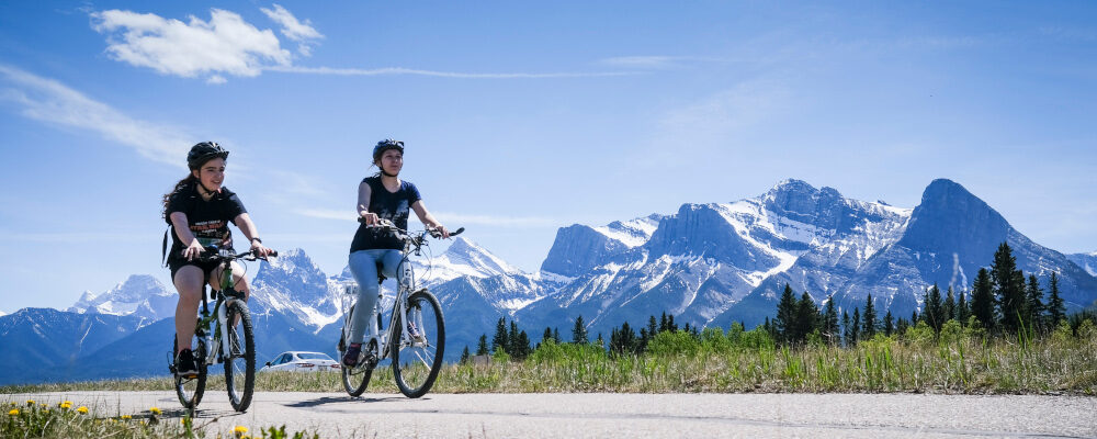 Cyclists use a pathway system in Canmore, Alta., Saturday, May 29, 2021. Jeff McIntosh/The Canadian Press. 