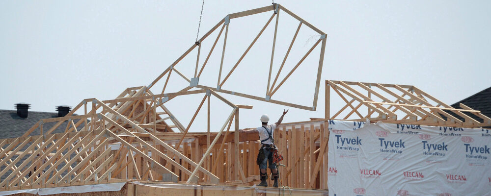 Construction workers build new homes in a development in Ottawa on Monday, July 6, 2015. Sean Kilpatrick/The Canadian Press.